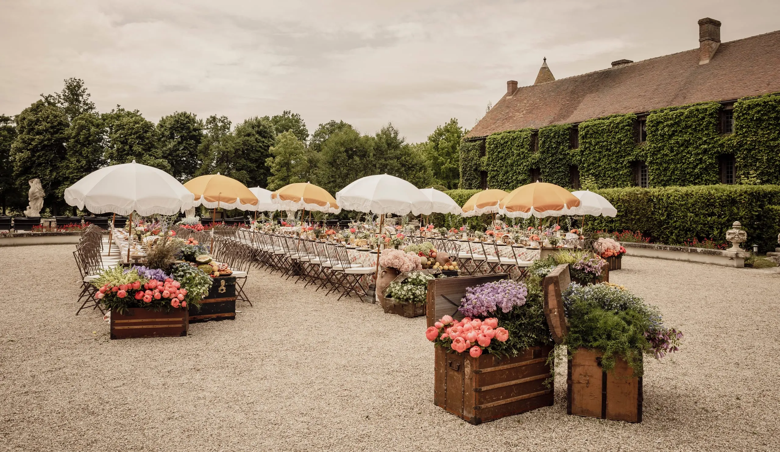 Déjeuner sous des parasols à franges devant un château